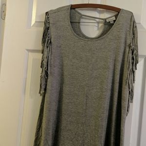 Grey t top with fringed sleeve.